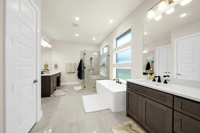 a large white kitchen with a sink and cabinets