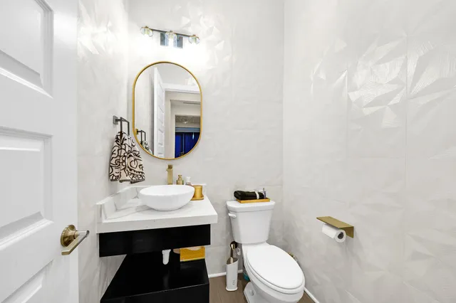 a bathroom with a toilet sink and mirror