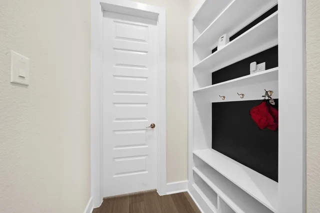 a view of walk in closet with clothes