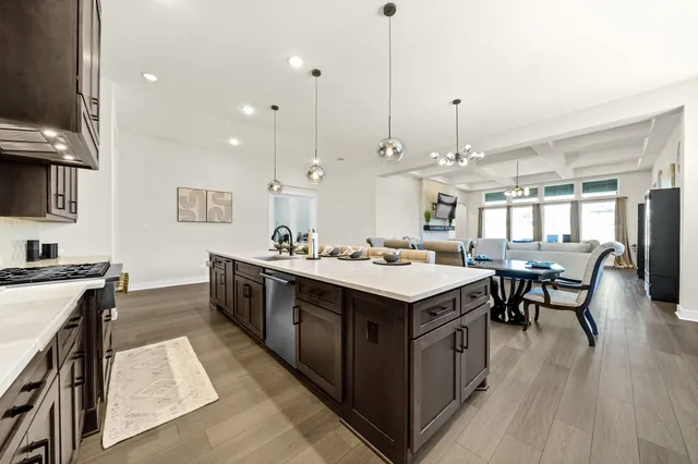 a large kitchen with kitchen island a sink table and chairs