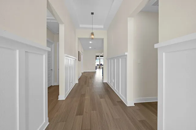 a view of a hallway with wooden floor