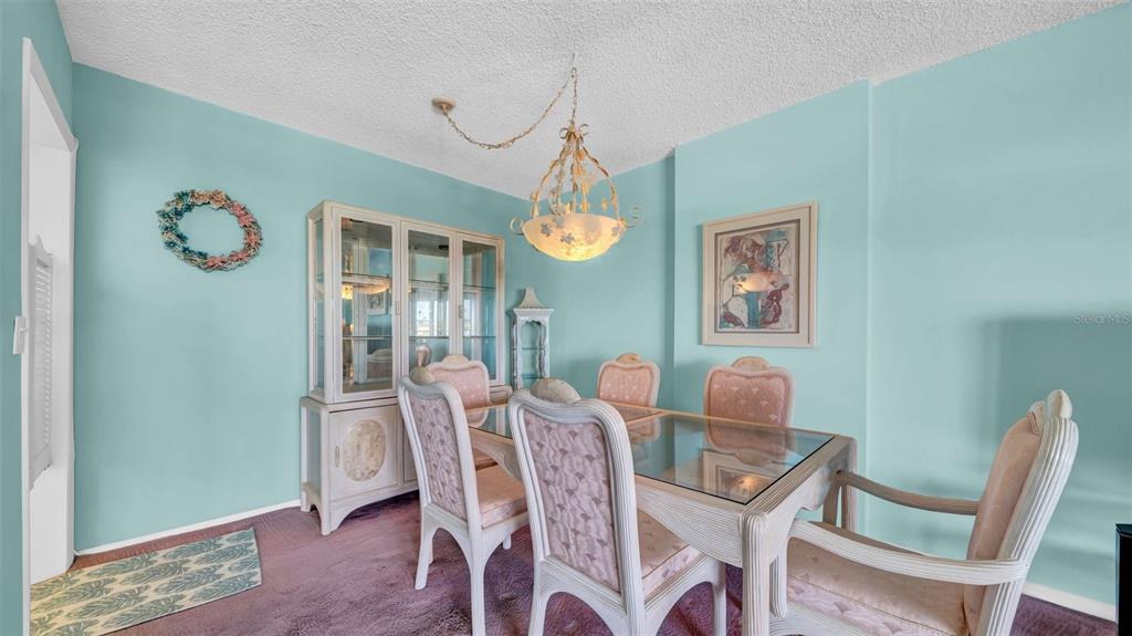 17400 Gulf Boulevard, Unit I4 North Redington Beach, FL 33708 - Photo 11 of 30 a dining room with furniture a rug and wooden floor