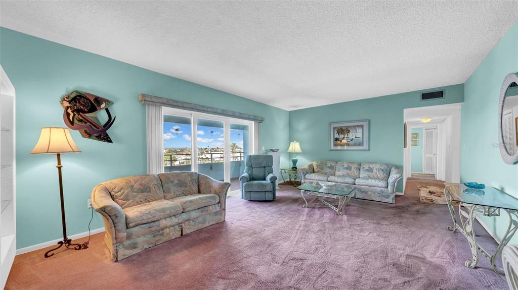17400 Gulf Boulevard, Unit I4 North Redington Beach, FL 33708 - Photo 13 of 30 a living room with furniture and a lamp