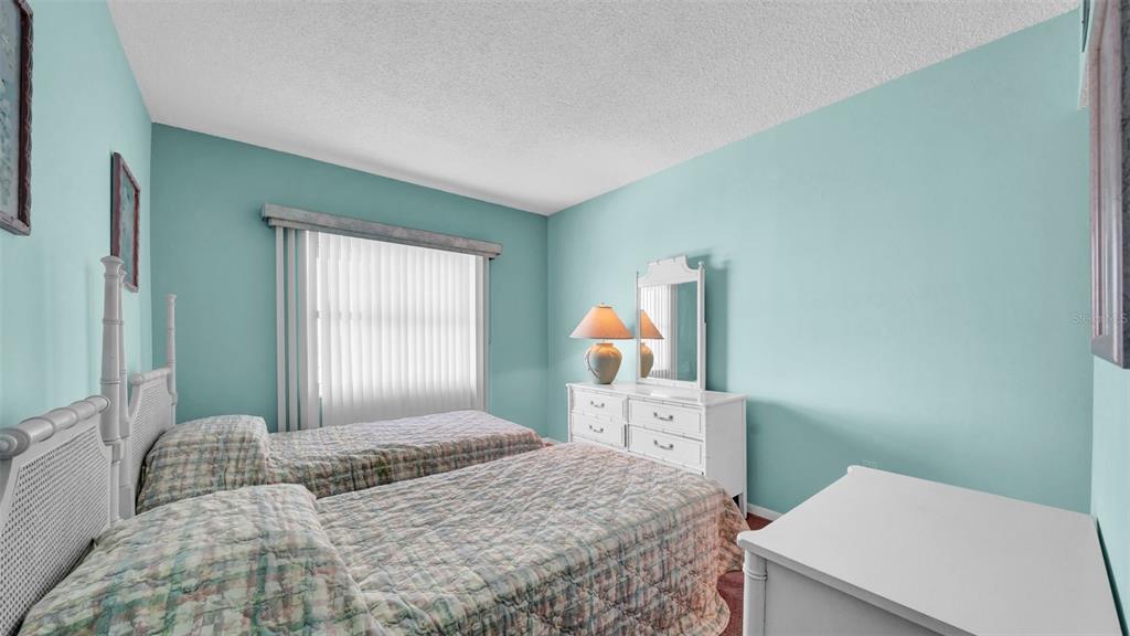 17400 Gulf Boulevard, Unit I4 North Redington Beach, FL 33708 - Photo 22 of 30 a bedroom with a bed and large windows