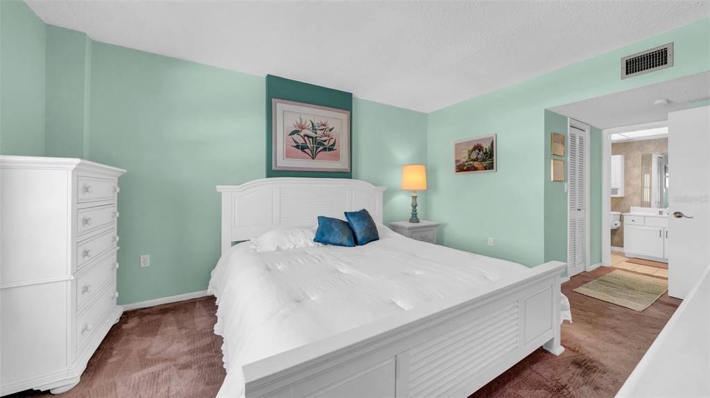 17400 Gulf Boulevard, Unit I4 North Redington Beach, FL 33708 - Photo 27 of 30 a bedroom with a bed and a painting on the wall