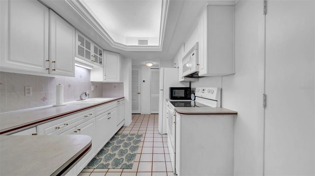 17400 Gulf Boulevard, Unit I4 North Redington Beach, FL 33708 - Photo 8 of 30 a kitchen with stainless steel appliances granite countertop a sink and a stove