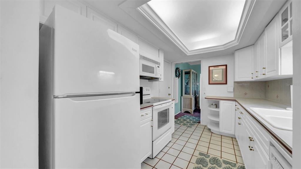 17400 Gulf Boulevard, Unit I4 North Redington Beach, FL 33708 - Photo 9 of 30 a kitchen with white cabinets and white appliances