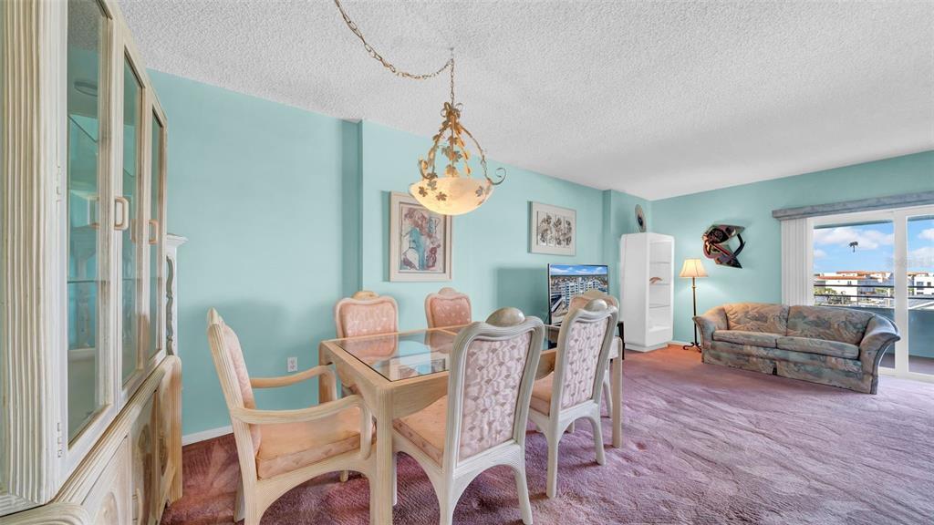 17400 Gulf Boulevard, Unit I4 North Redington Beach, FL 33708 - Photo 10 of 30 a dining room with furniture a chandelier and wooden floor