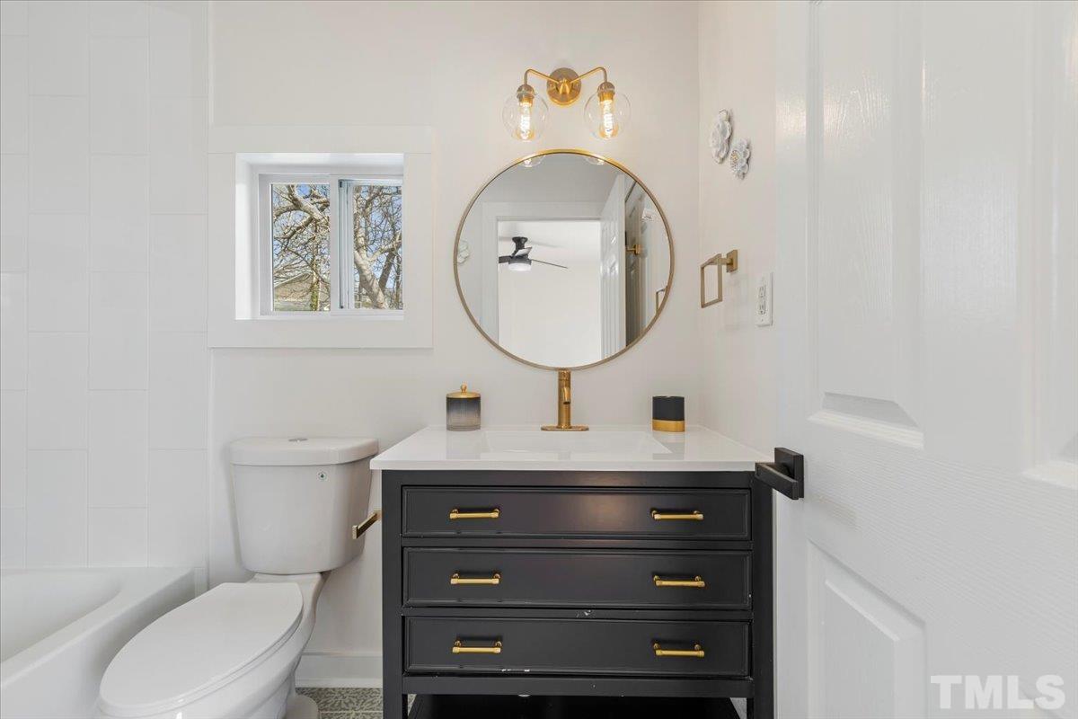 1100 Chester Street Durham, NC 27701 - Photo 22 of 43 a bathroom with a toilet a sink and mirror