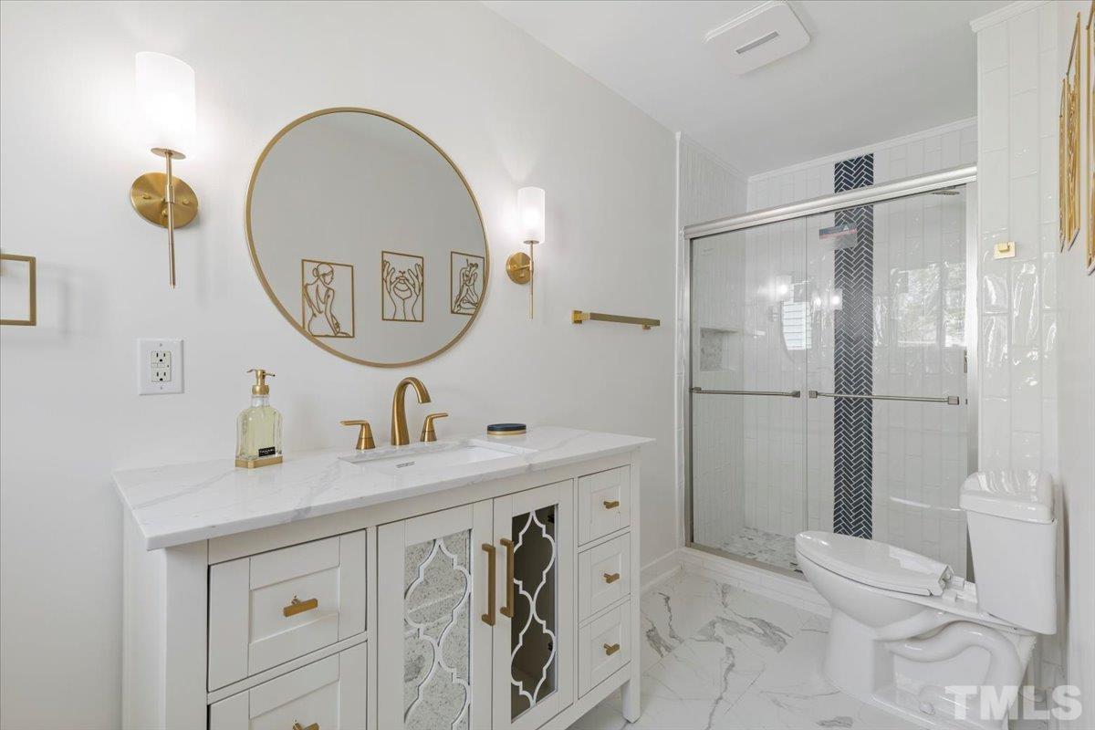 1100 Chester Street Durham, NC 27701 - Photo 24 of 43 a bathroom with a sink a mirror a vanity and a shower