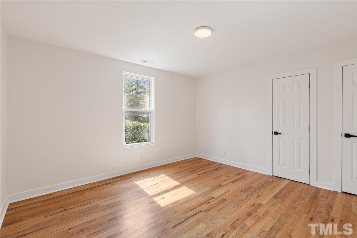 1100 Chester Street Durham, NC 27701 - Photo 32 of 43 an empty room with wooden floor and windows