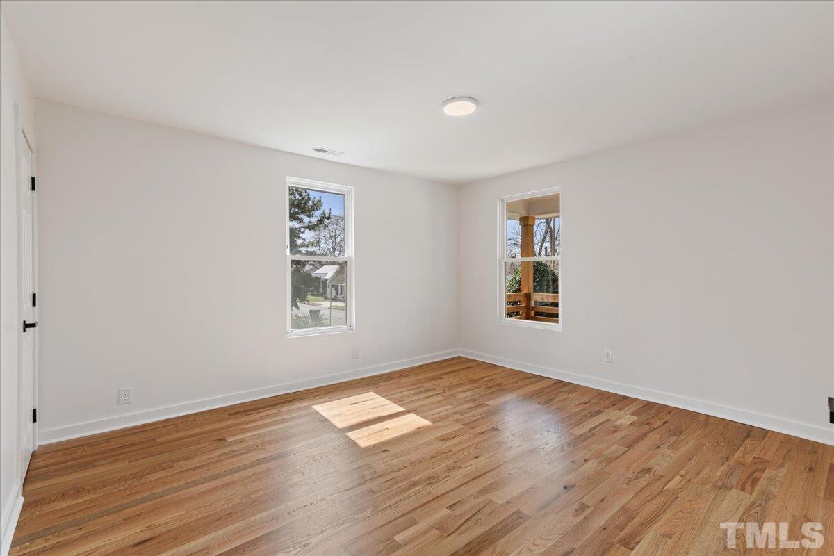 1100 Chester Street Durham, NC 27701 - Photo 35 of 43 a view of an empty room with wooden floor and a window