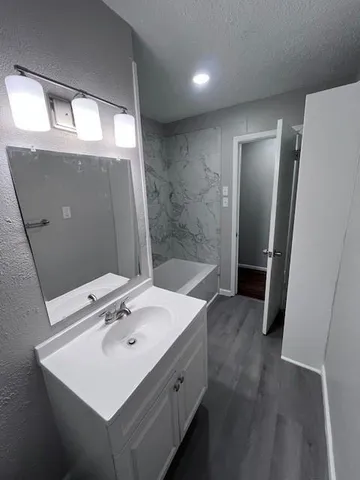 a bathroom with a sink a mirror and shower