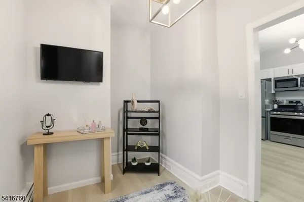 a kitchen with stainless steel appliances a stove microwave and sink