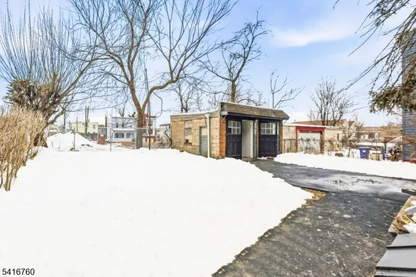 a view of a building with snow on the road