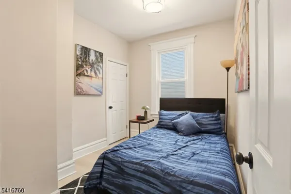 a bedroom with a bed and a potted plant
