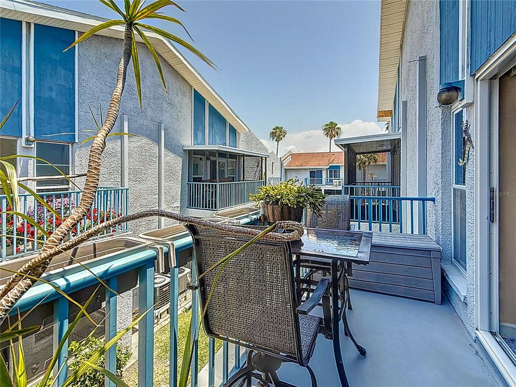 230 Medallion Boulevard, Unit G Madeira Beach, FL 33708 - Photo 30 of 38 a view of a house with backyard and sitting area