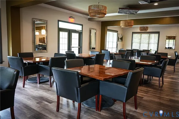 a large dining space with lots of furniture and chandelier