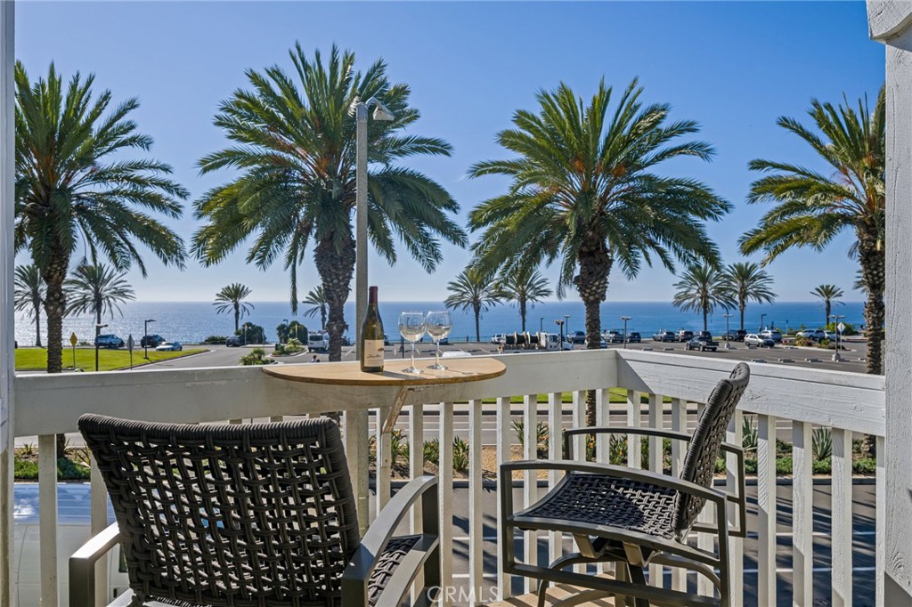 34126 Selva Road, Unit 303 Dana Point, CA 92629 - Photo 1 of 1 a view of a swimming pool with a table and chairs