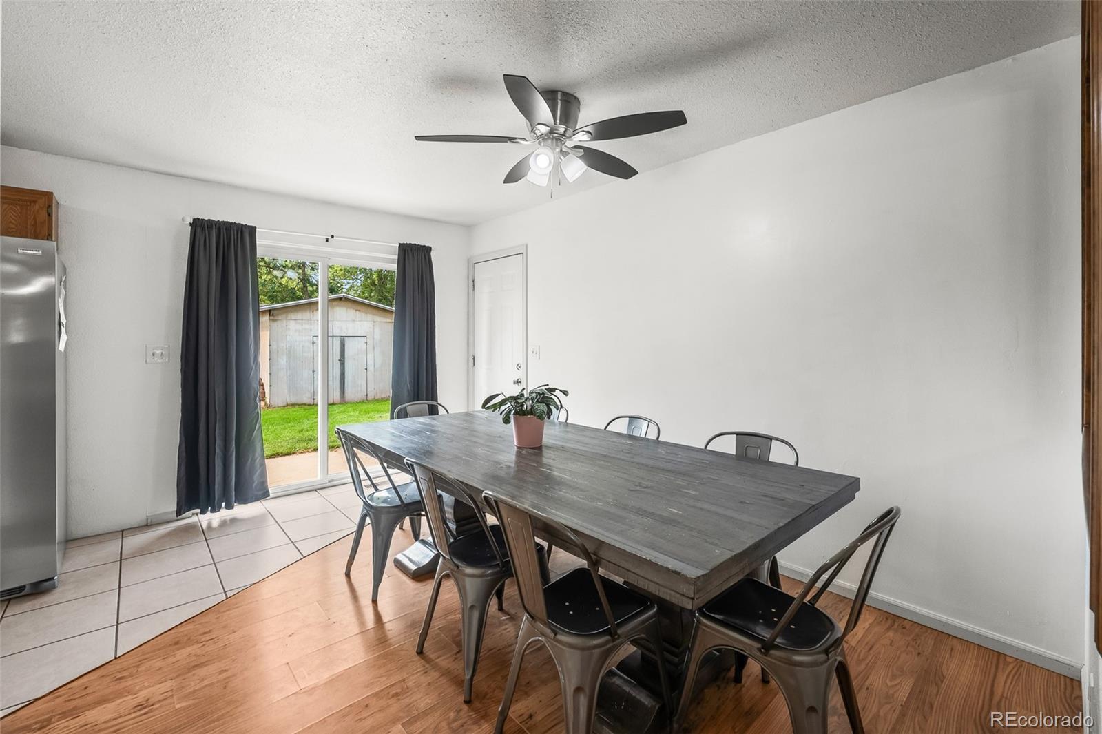 908 Trapper Drive Fort Lupton, CO 80621 - Photo 12 of 41 a view of a dining room with furniture window and wooden floor
