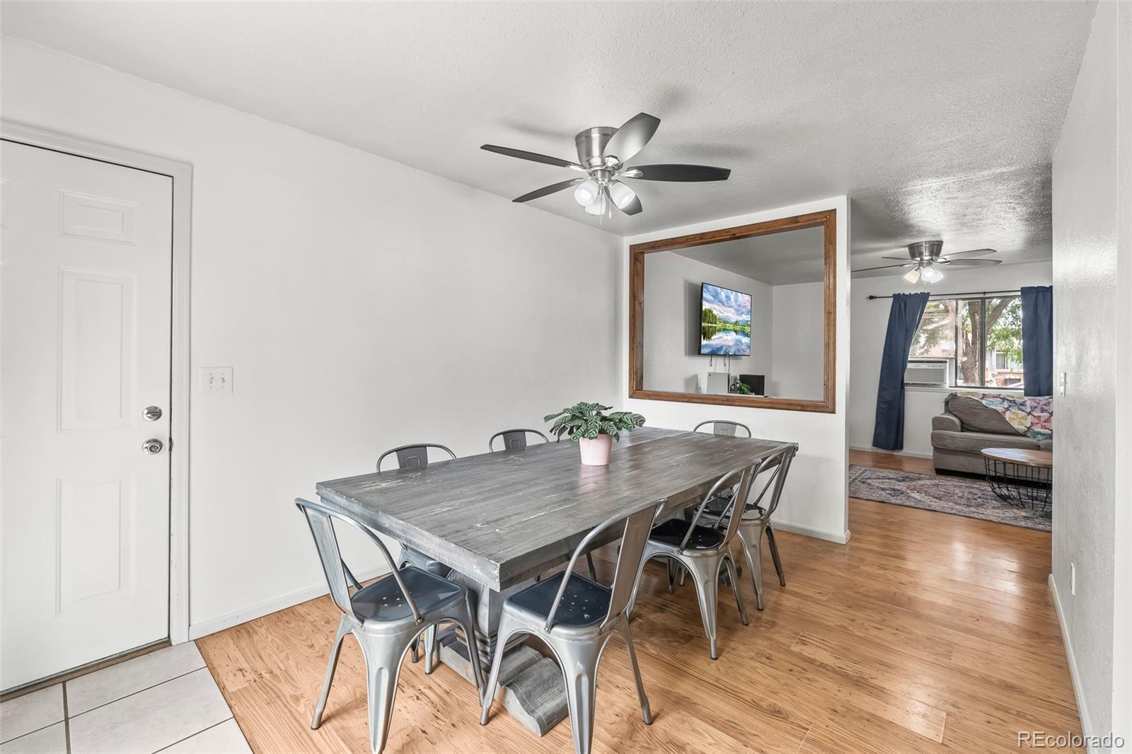908 Trapper Drive Fort Lupton, CO 80621 - Photo 13 of 41 a view of a dining room with furniture and wooden floor