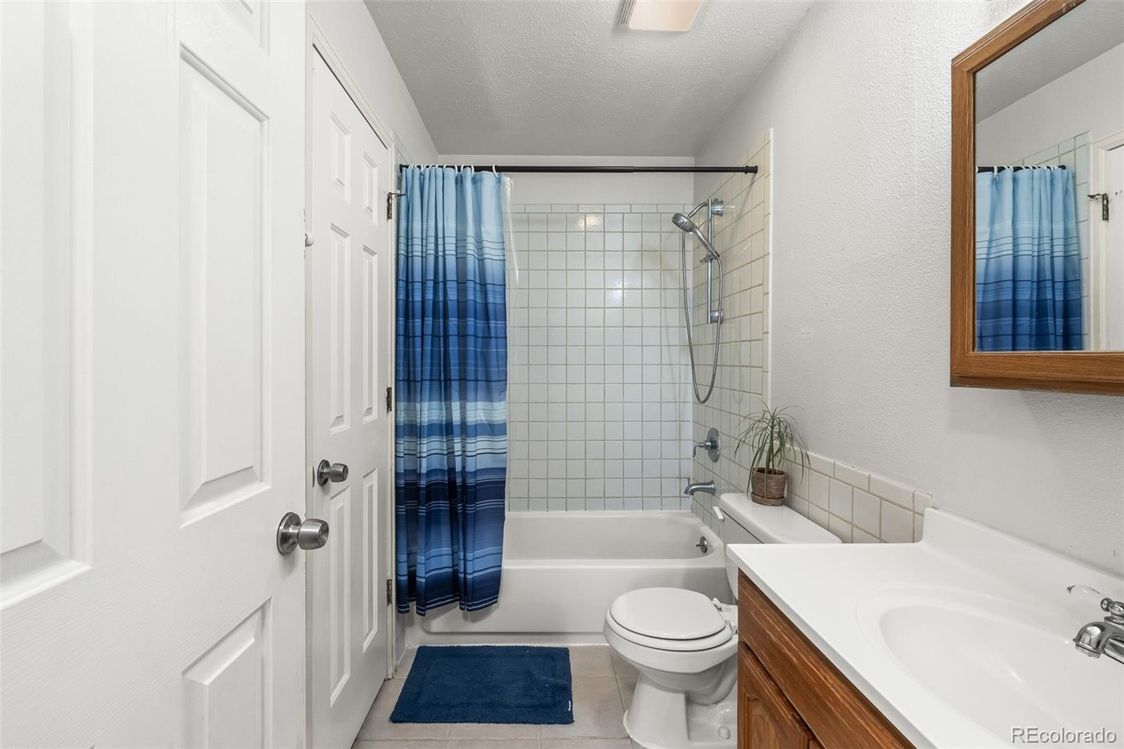 908 Trapper Drive Fort Lupton, CO 80621 - Photo 20 of 41 a bathroom with a sink toilet and shower