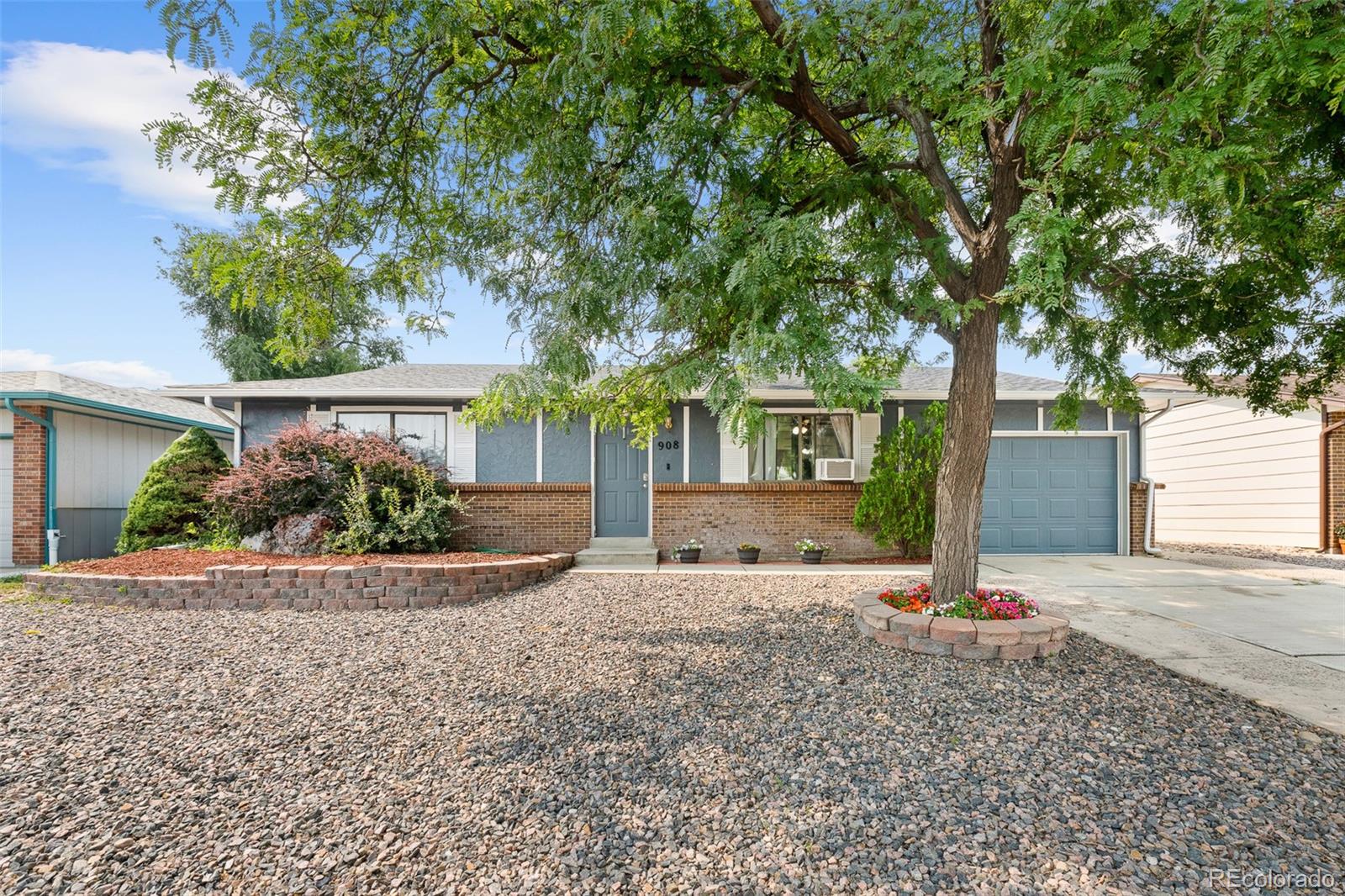 908 Trapper Drive Fort Lupton, CO 80621 - Photo 2 of 41 front view of a house with a yard and an trees