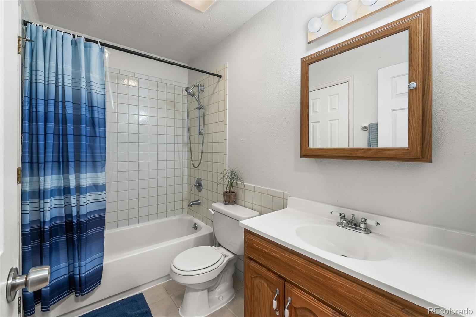 908 Trapper Drive Fort Lupton, CO 80621 - Photo 21 of 41 a bathroom with a sink a toilet and shower