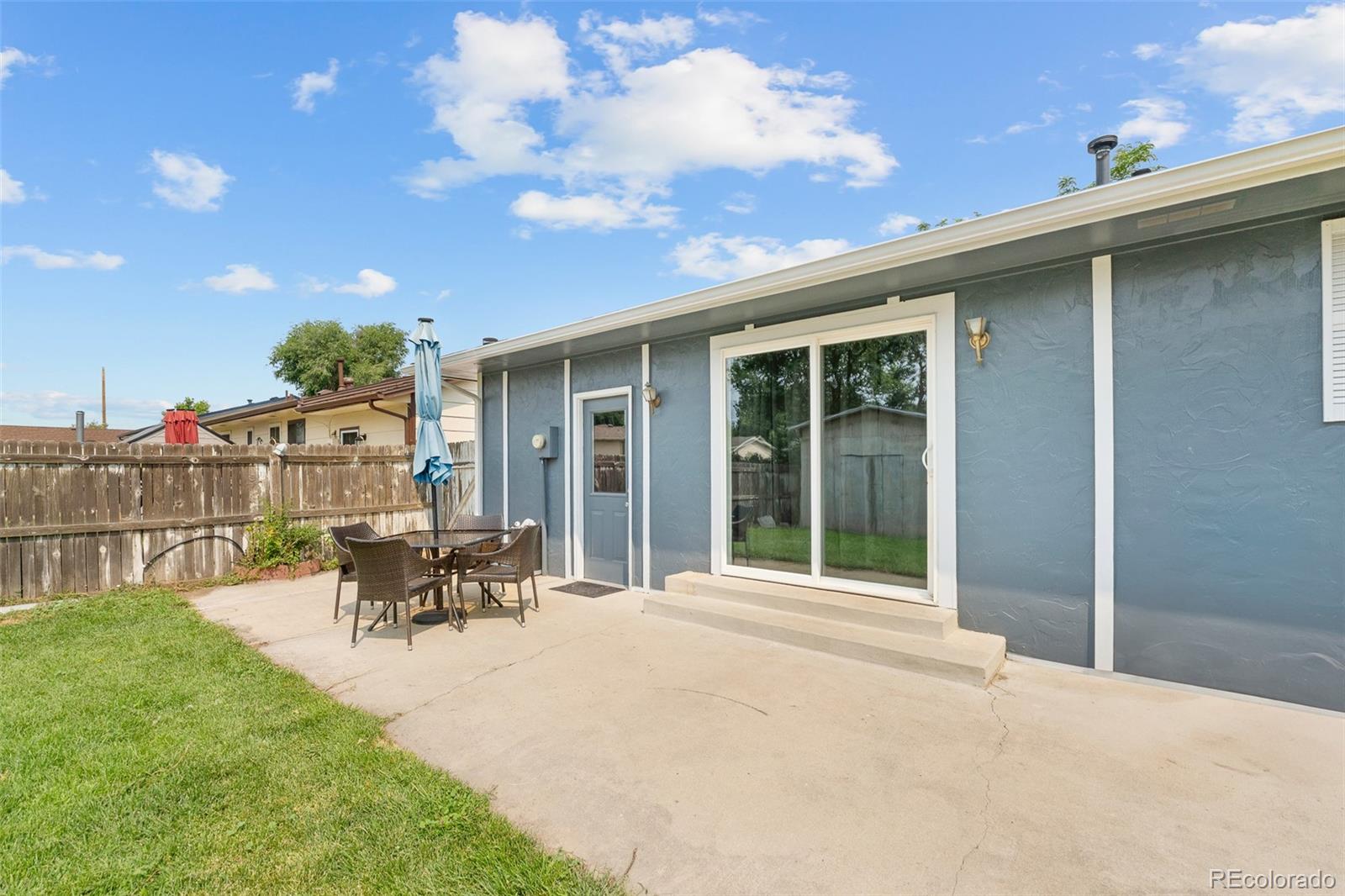 908 Trapper Drive Fort Lupton, CO 80621 - Photo 24 of 41 a view of a patio with table and chairs and potted plants