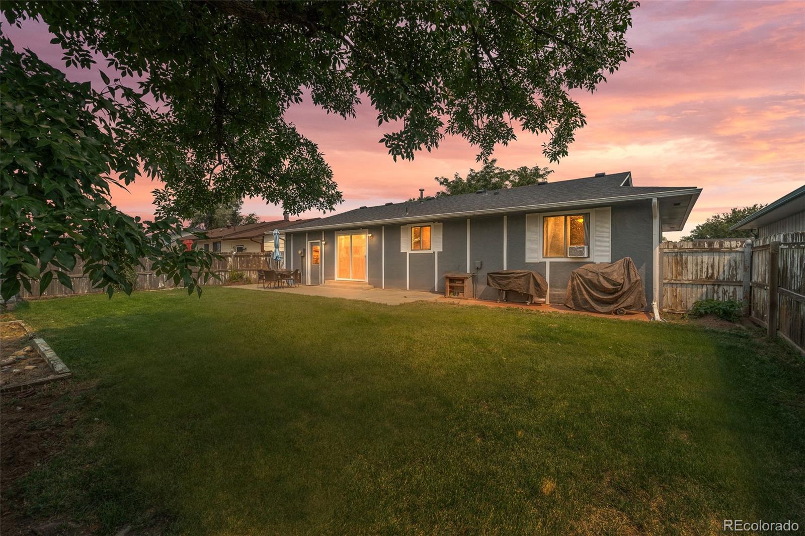 908 Trapper Drive Fort Lupton, CO 80621 - Photo 25 of 41 a front view of house with yard and green space