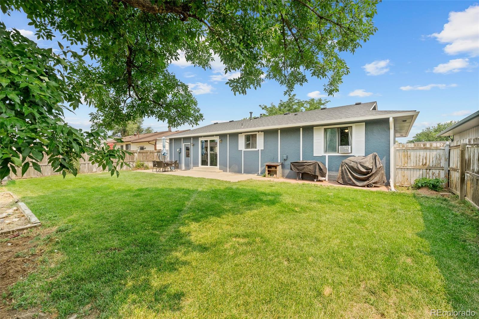 908 Trapper Drive Fort Lupton, CO 80621 - Photo 28 of 41 a view of a house with backyard sitting area and garden