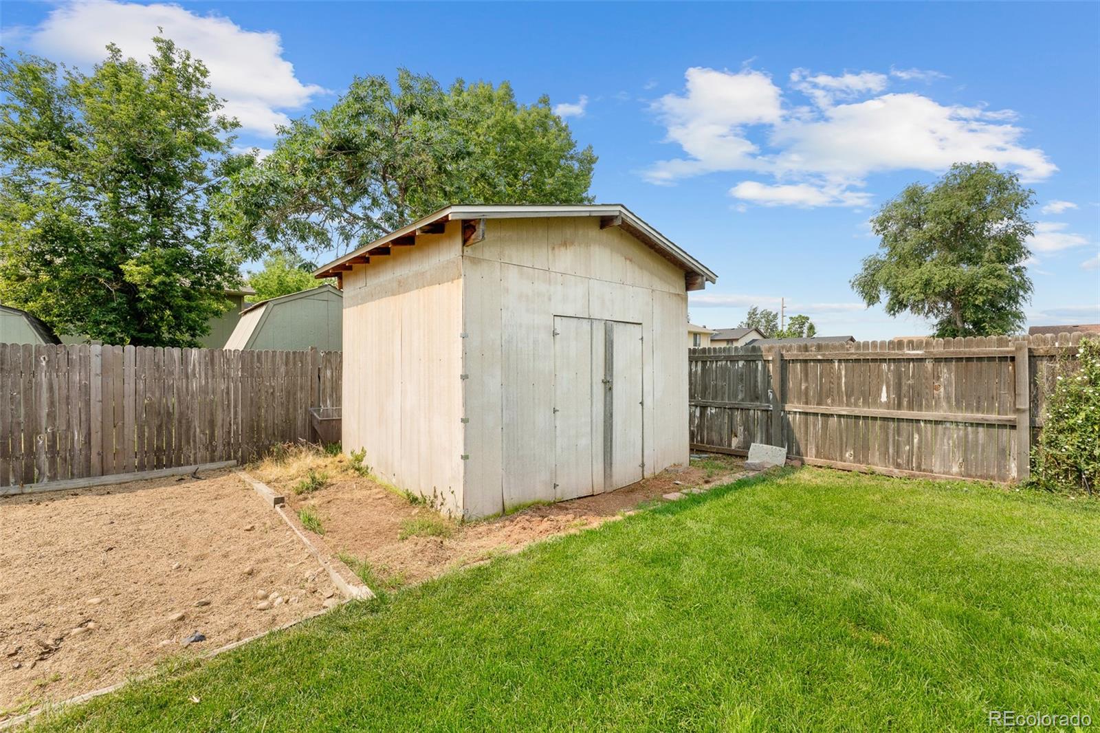 908 Trapper Drive Fort Lupton, CO 80621 - Photo 30 of 41 a view of backyard with small cabin