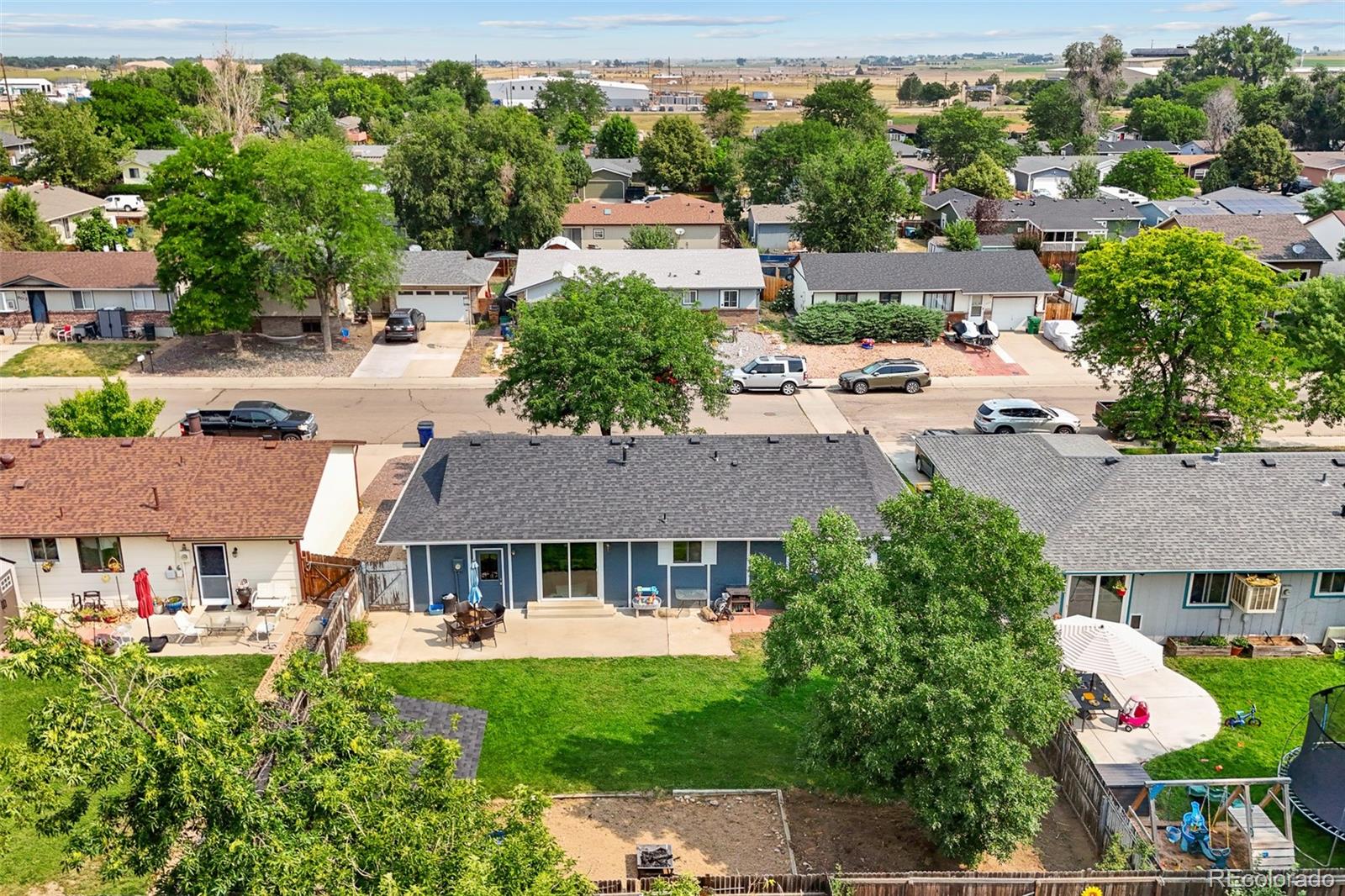 908 Trapper Drive Fort Lupton, CO 80621 - Photo 33 of 41 an aerial view of a house with garden space and street view