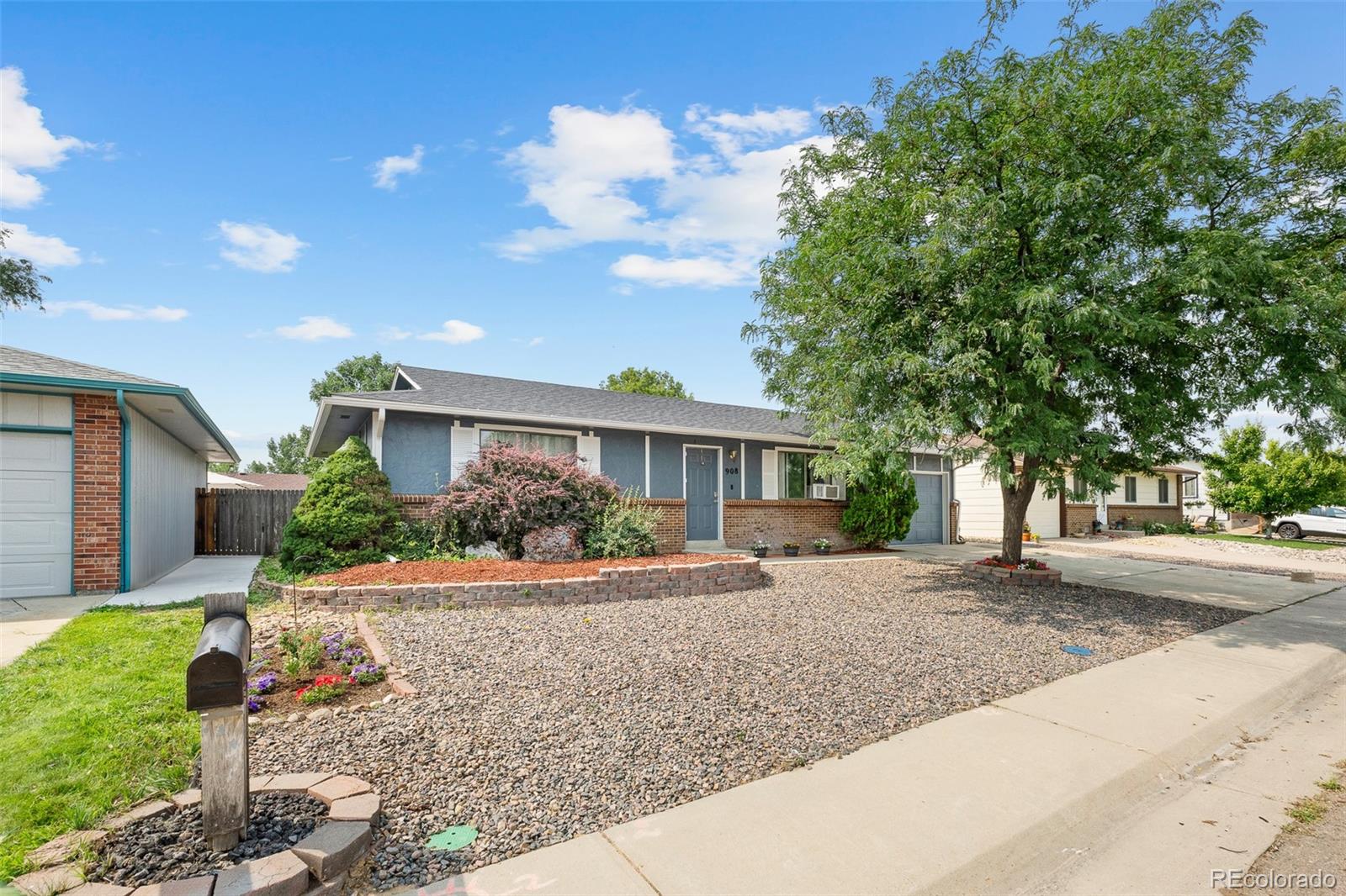908 Trapper Drive Fort Lupton, CO 80621 - Photo 5 of 41 a front view of a house with yard and a tree