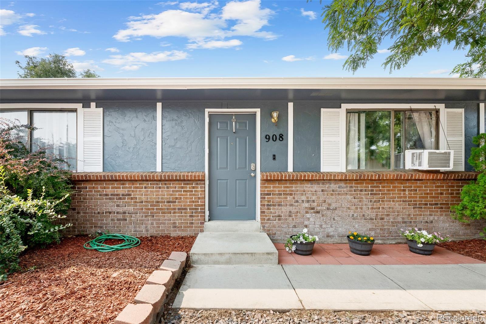 908 Trapper Drive Fort Lupton, CO 80621 - Photo 6 of 41 front view of a house with potted plants