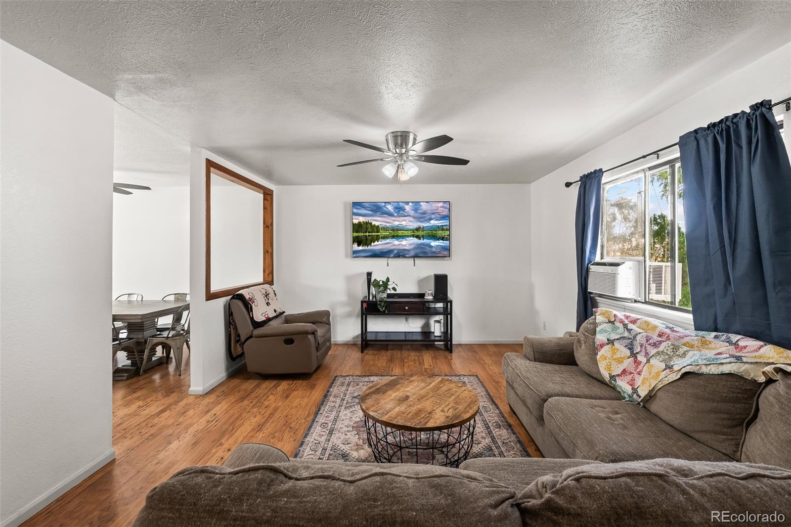 908 Trapper Drive Fort Lupton, CO 80621 - Photo 8 of 41 a living room with furniture and a large window