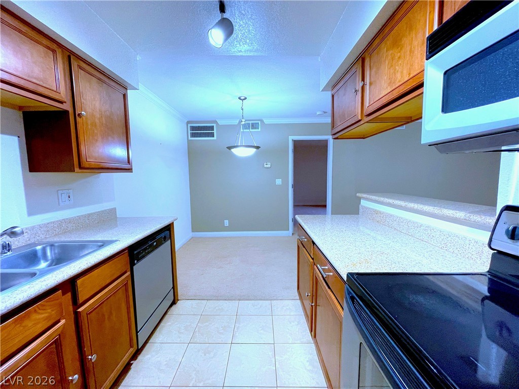 3135 South Mojave Road, Unit 156 Las Vegas, NV 89121 - Photo 7 of 18 A compact kitchen with sleek appliances seamlessly flows into a welcoming dining area.