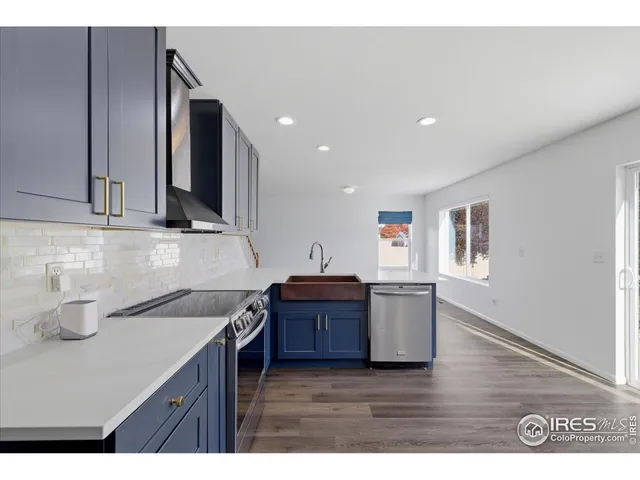a kitchen with cabinets and wooden floor