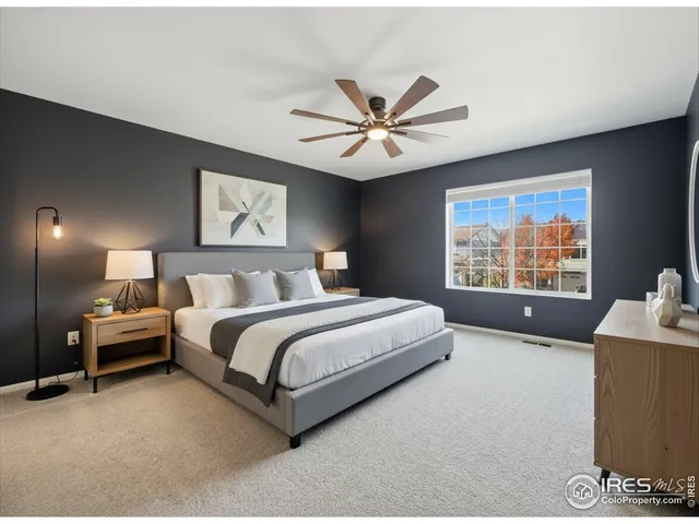 a spacious bedroom with a bed and a couch