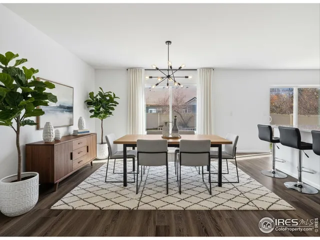a living room with furniture a chandelier and a rug