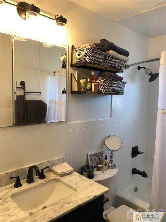 57 Judson Street, Unit 1B Edison, NJ 08837 - Photo 12 of 21 a bathroom with a sink and a mirror