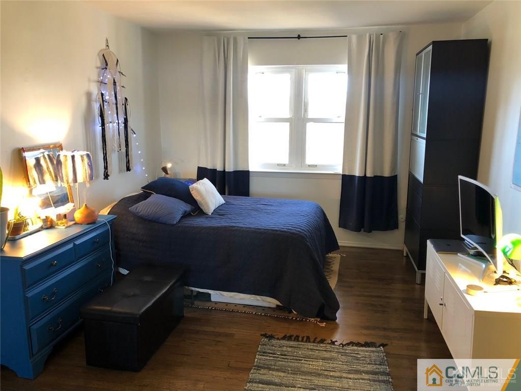 57 Judson Street, Unit 1B Edison, NJ 08837 - Photo 13 of 21 a bedroom with a bed tv and a window