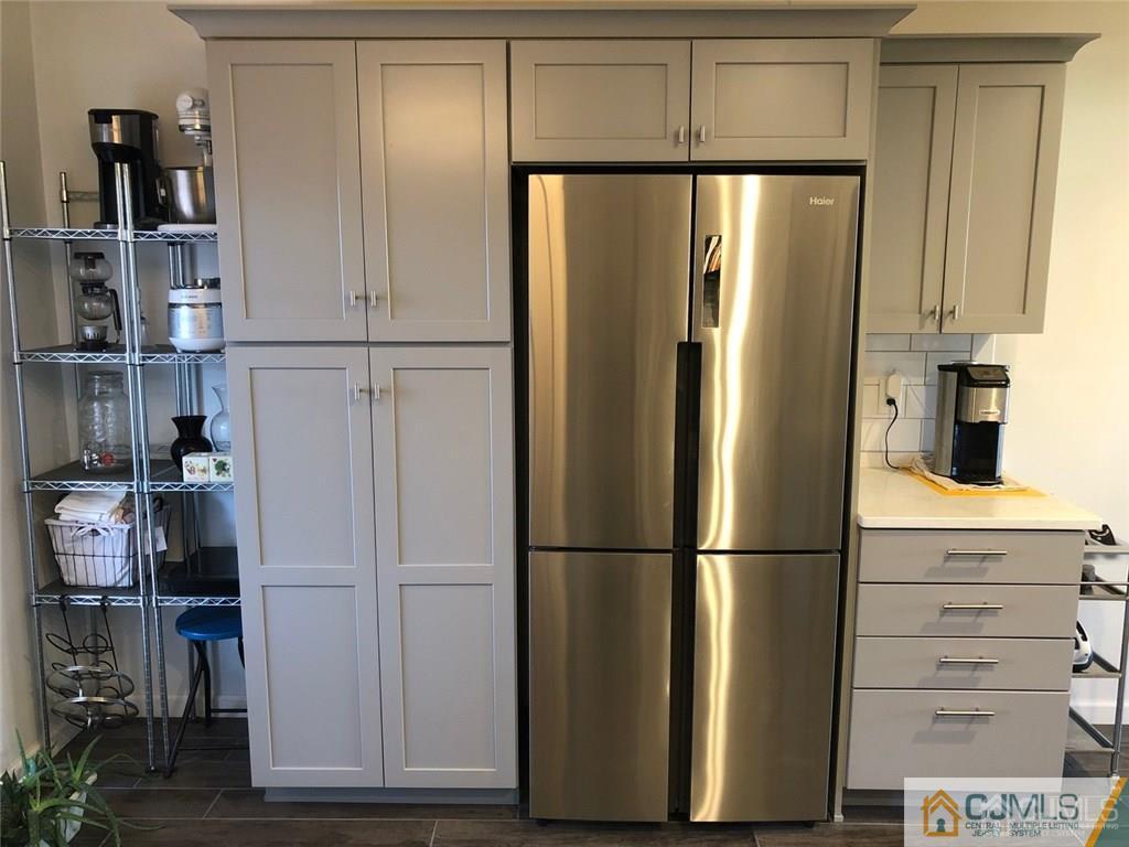 57 Judson Street, Unit 1B Edison, NJ 08837 - Photo 9 of 21 a metallic refrigerator freezer sitting in a kitchen
