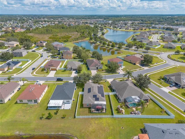 an aerial view of swimming pool with outdoor seating