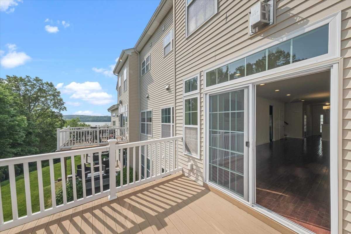 2507 Sylvan Loop Fishkill, NY 12590 - Photo 26 of 37 a view of a balcony with a floor to ceiling window and wooden floor