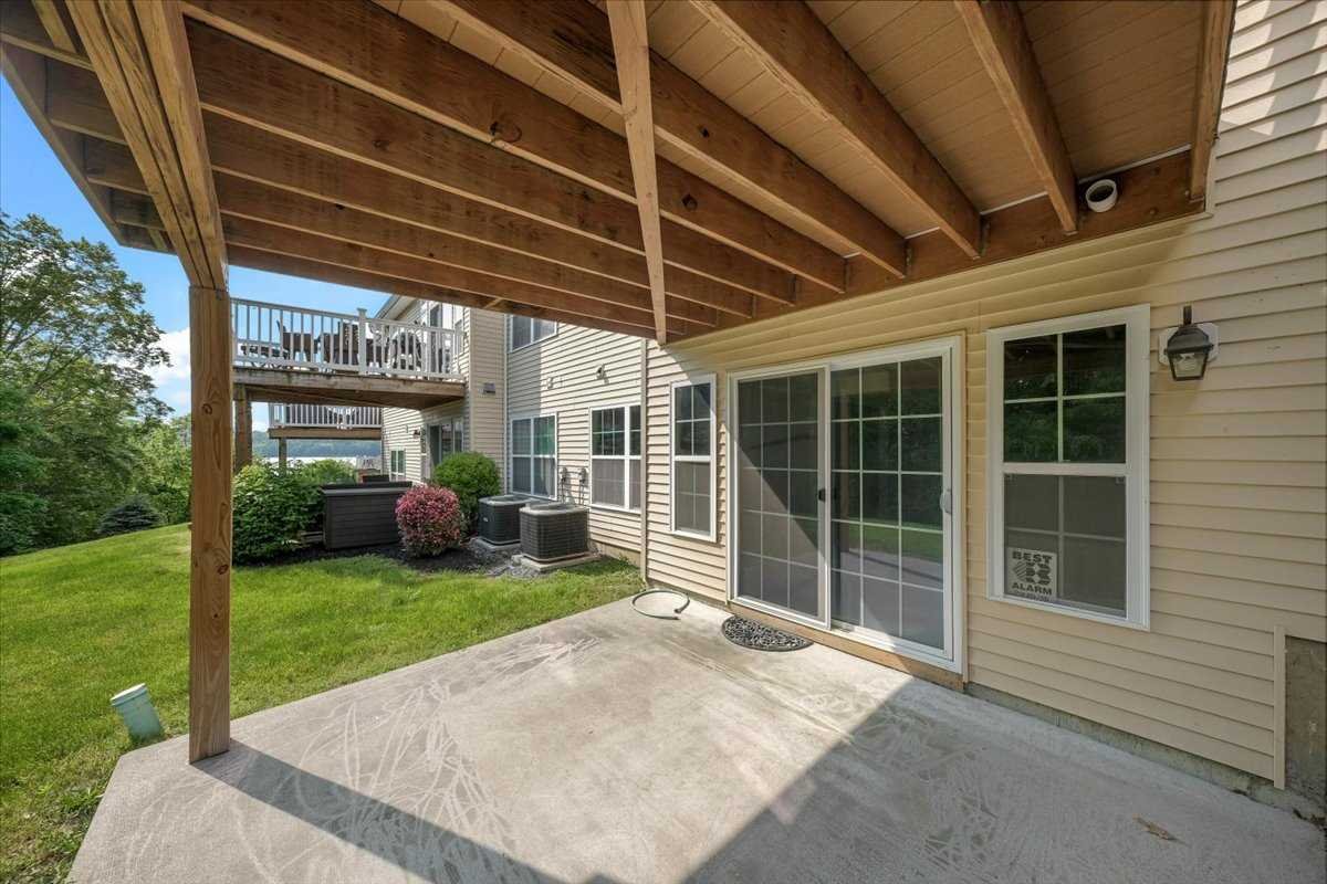 2507 Sylvan Loop Fishkill, NY 12590 - Photo 27 of 37 a view of a backyard with table and chairs and wooden fence