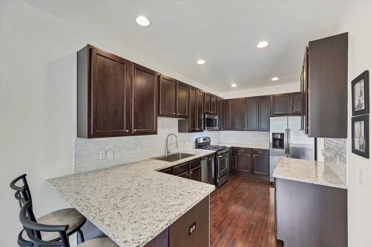 2507 Sylvan Loop Fishkill, NY 12590 - Photo 10 of 37 a kitchen with center island table chairs sink and cabinets
