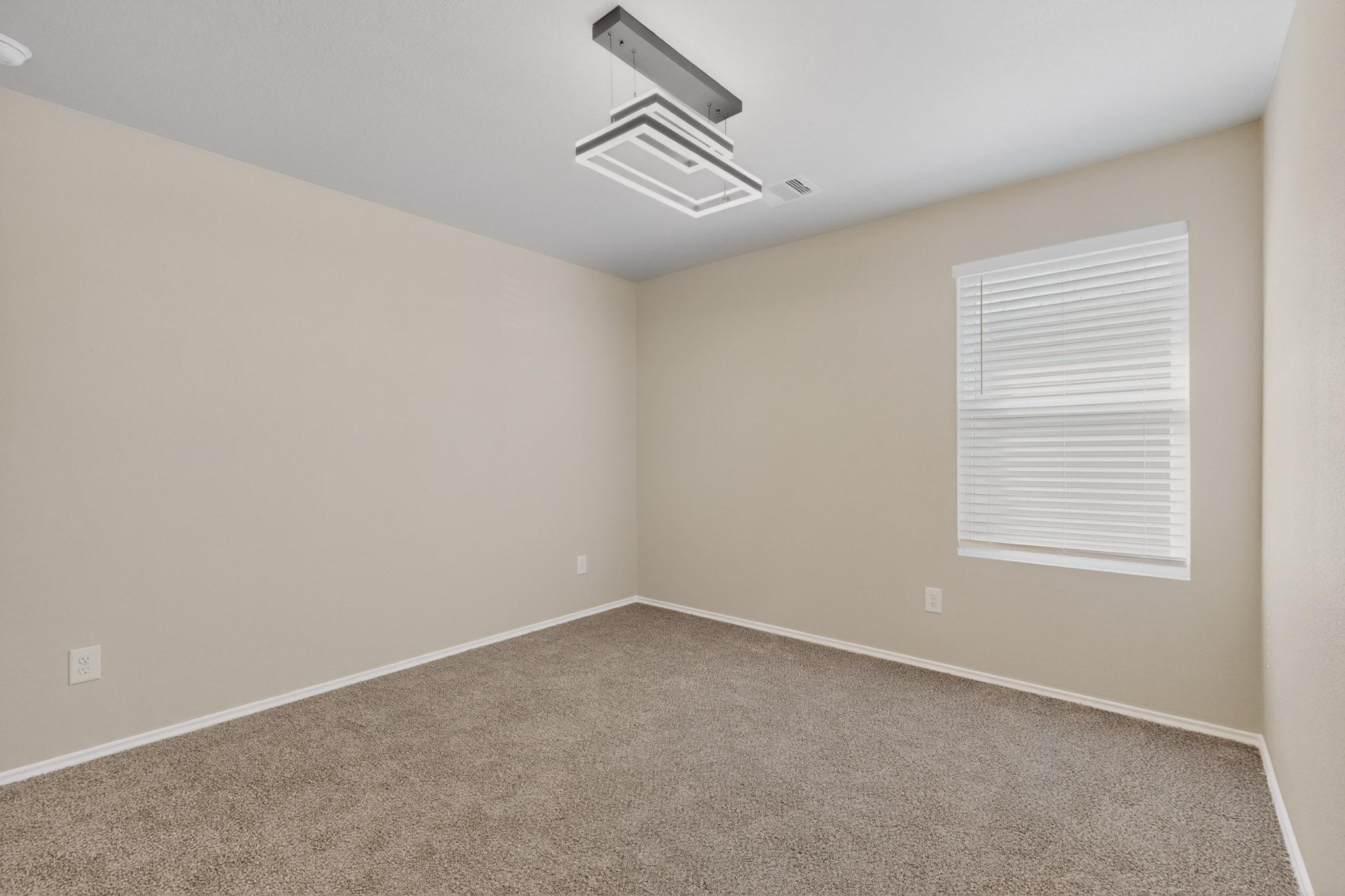 218 Sickle Loop Kyle, TX 78640 - Photo 17 of 34 Carpeted spare room featuring baseboards and cooling unit
