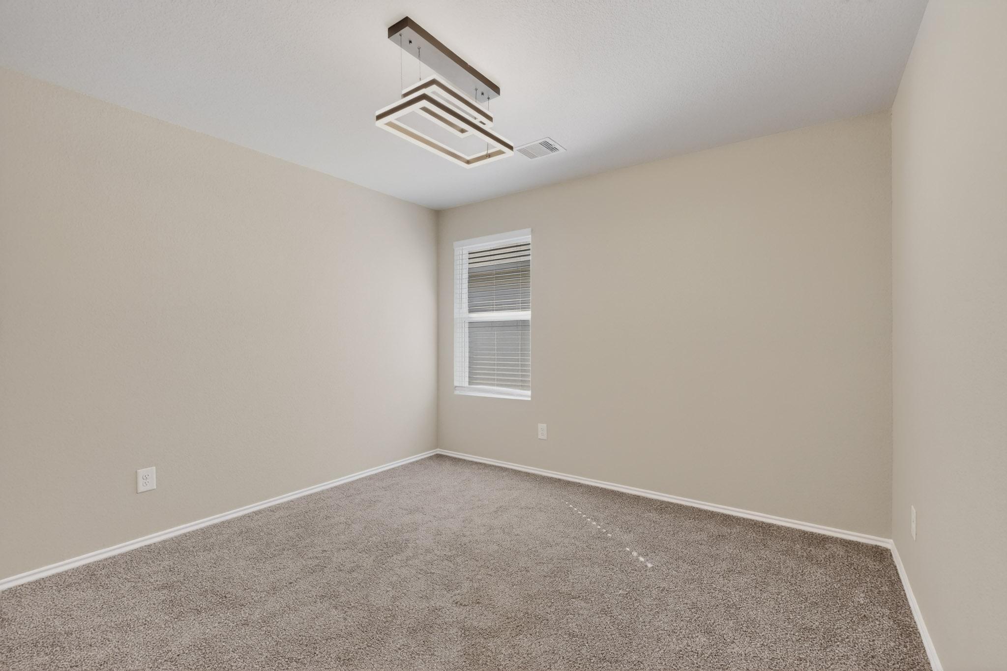 218 Sickle Loop Kyle, TX 78640 - Photo 18 of 34 Carpeted empty room with baseboards