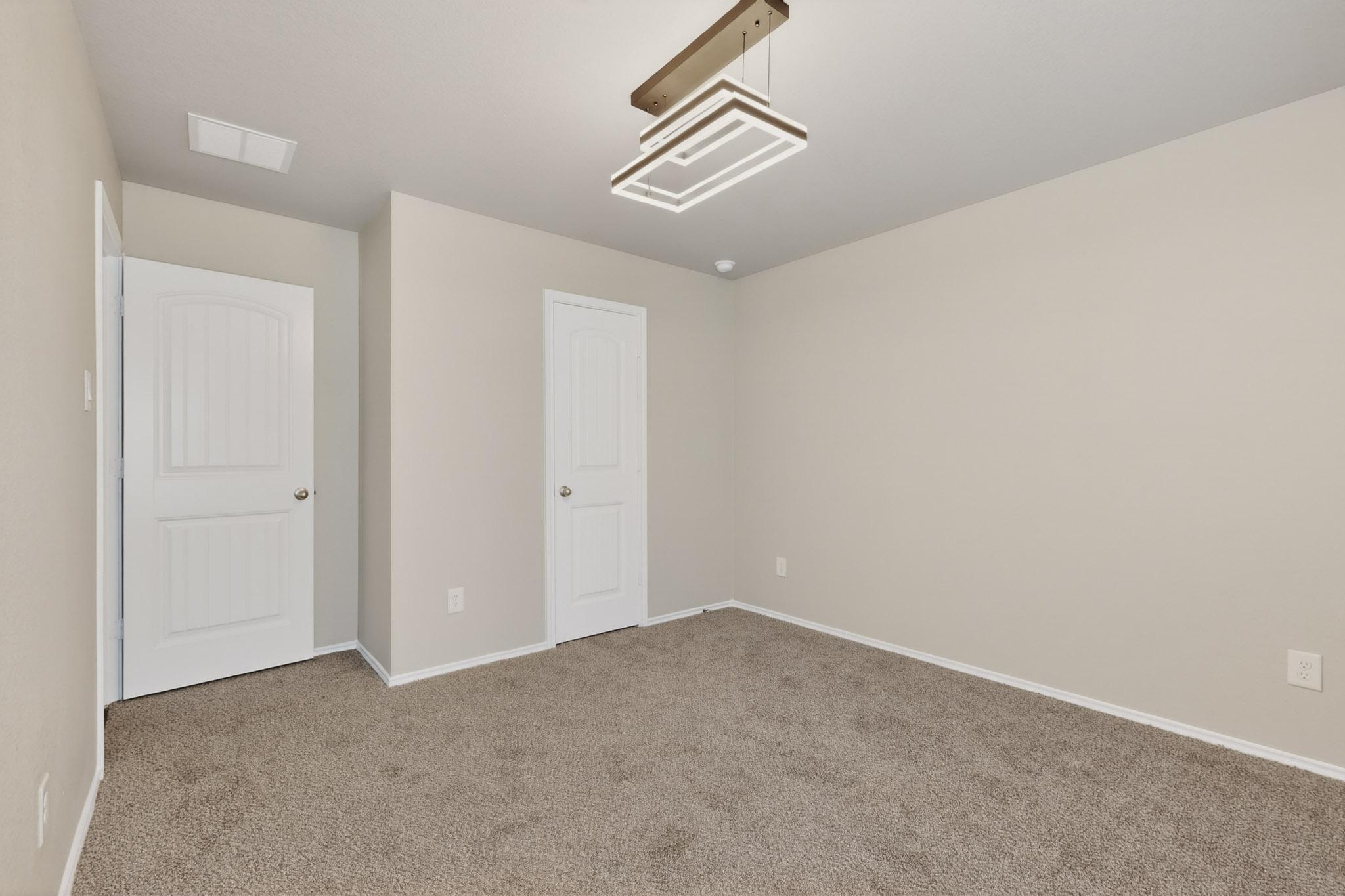 218 Sickle Loop Kyle, TX 78640 - Photo 19 of 34 Unfurnished bedroom featuring carpet and baseboards